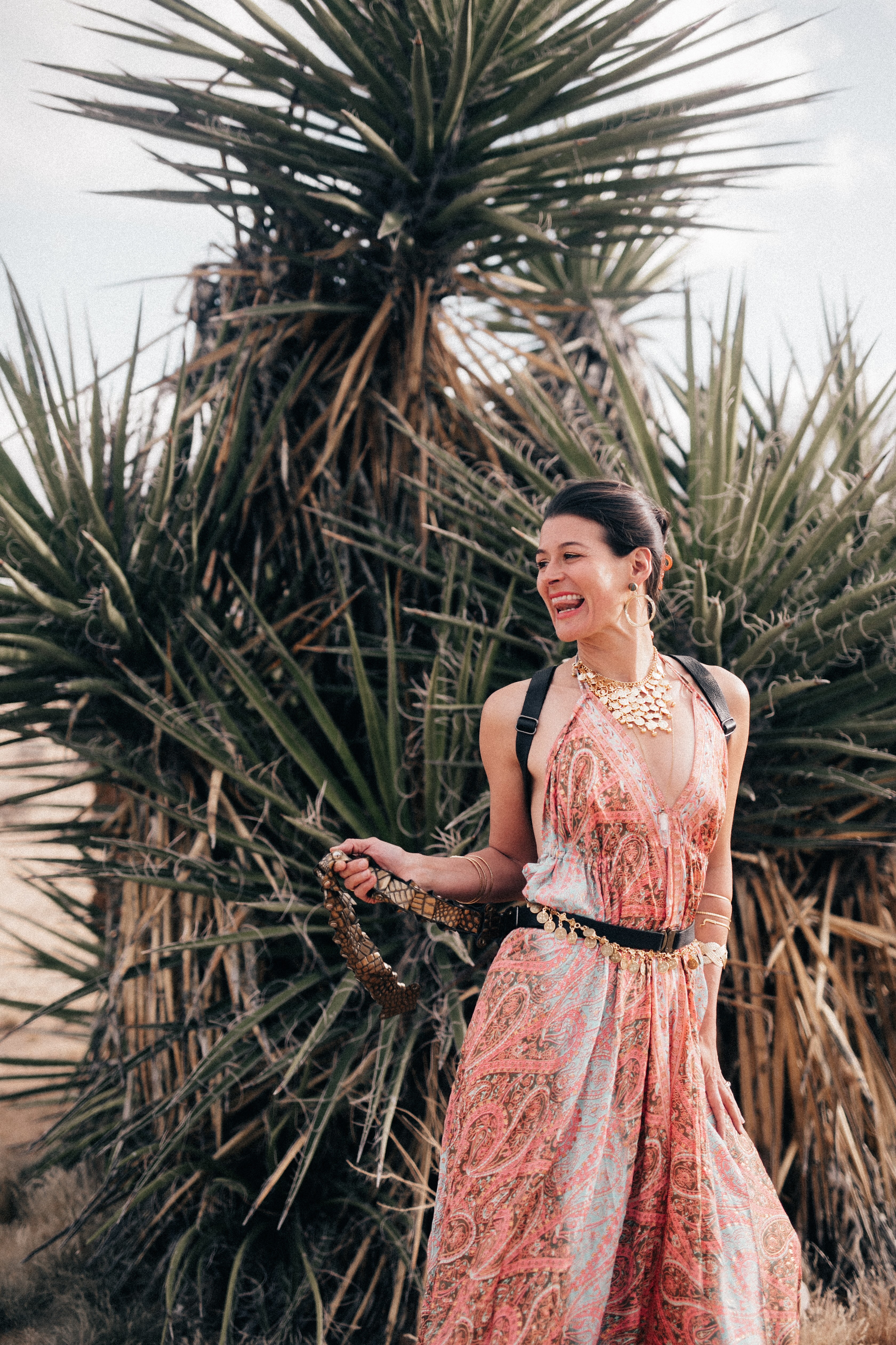 Claudia in the desert, holding her belt